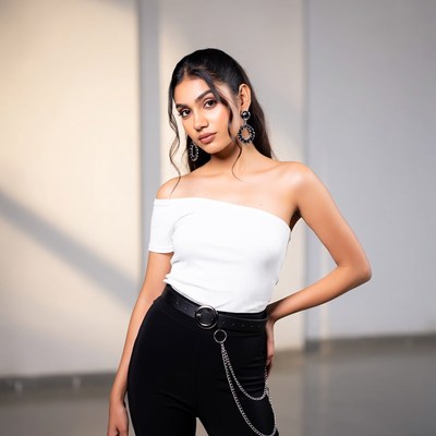 Model poses in bright studio space