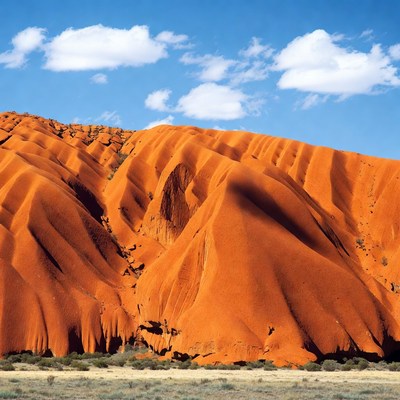 Massive orange rock formations under blue sky