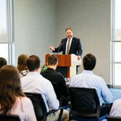 Speaker addresses audience in conference room