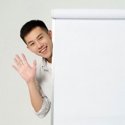 Man waving beside a blank board