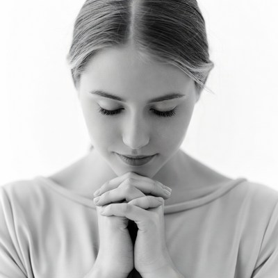 Woman with hands in prayer position