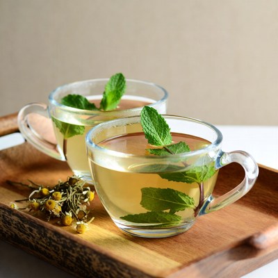 Herbal tea with mint on wooden tray