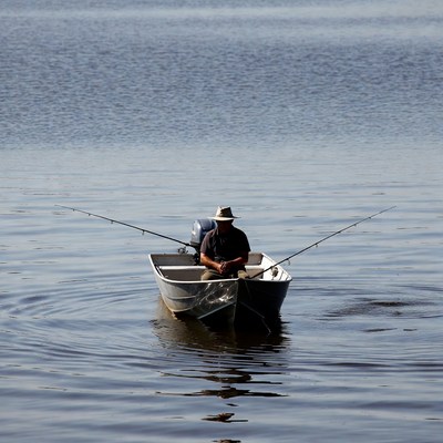 Person fishing on a calm water body