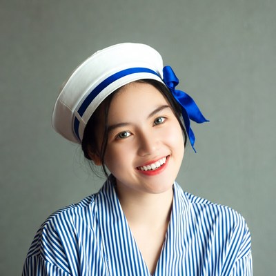 Young woman in sailor hat smiling