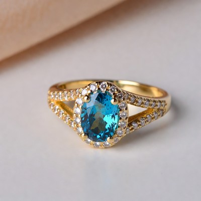 Gold ring with blue gemstone and stones