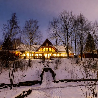 Winter cabin at night with lights