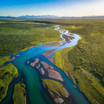Winding river flows through green land