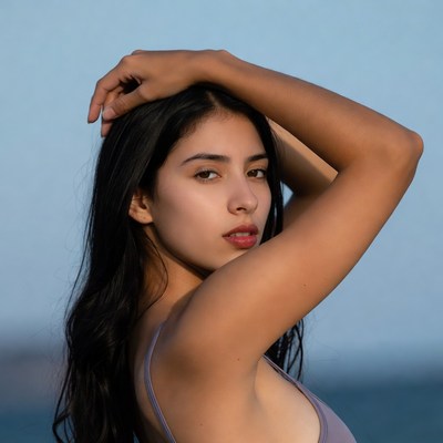 Woman posing by the beach during sunset