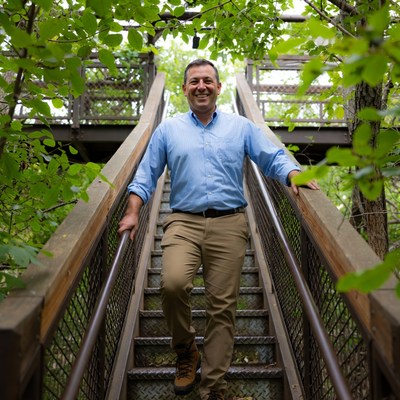 Man walking down forest steps