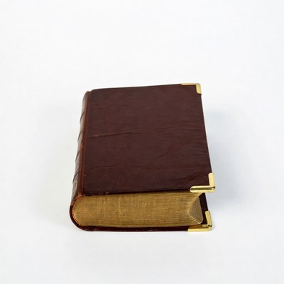 Old book with gold corners displayed