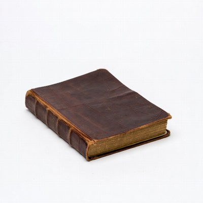 Old leather bound book on white background