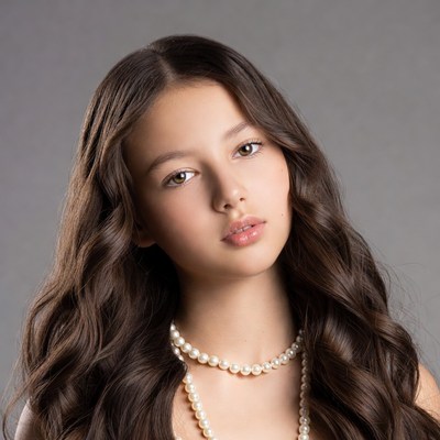 Young girl with long hair and pearls