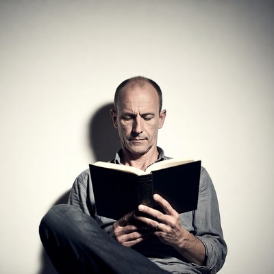 Man reading book in quiet space