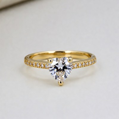 Elegant gold ring with heart stone on display