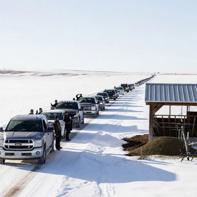 Long line of trucks in winter landscape