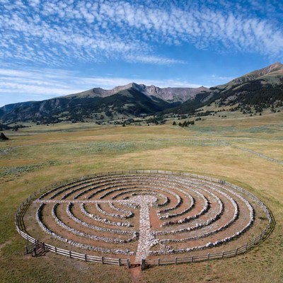 Labyrinth in open field with mountains