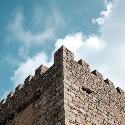 Stone castle tower under blue sky