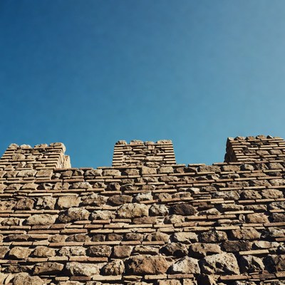 Historic stone wall under blue sky