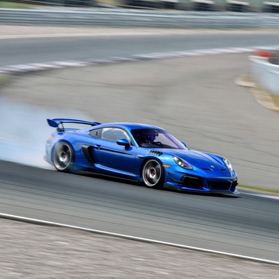 Car drifting on racetrack during day