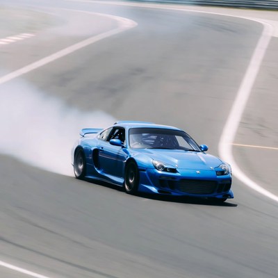 Car drifting on a racetrack in daylight