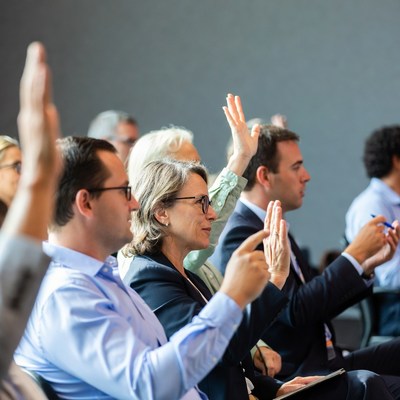 Audience raises hands for questions