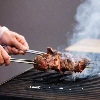 Grilling skewers at outdoor barbecue event