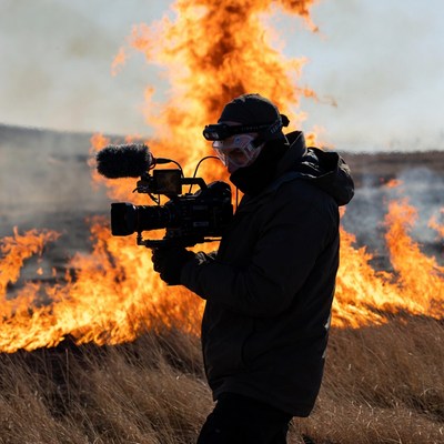 Filming a wildfire scene in the field