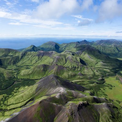 Mountains with green hills and ocean view