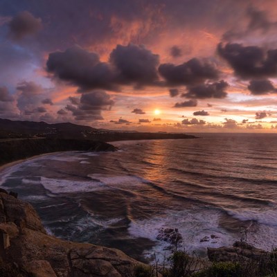 Sunset over the ocean at a coastal cliff