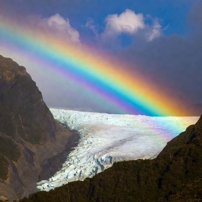 Rainbow over glacier landscape in mountains