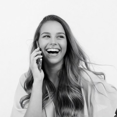 Woman laughing while talking on phone