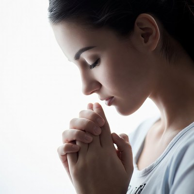 Woman with hands together in thought