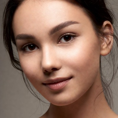 Young woman with long hair poses in studio