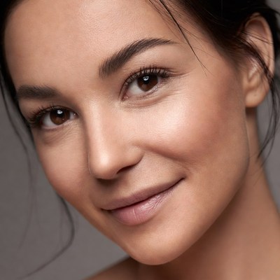 Woman smiles softly at the camera