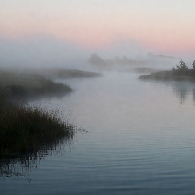 Morning fog over quiet water