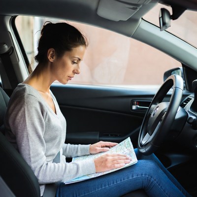 Driver reading map in car
