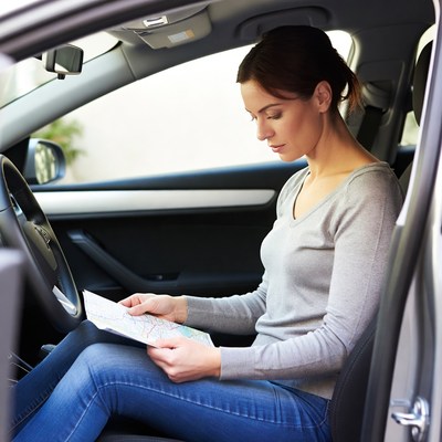 Woman reading map in car