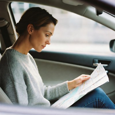 Woman reading map in car