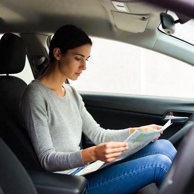 Woman reading map in car