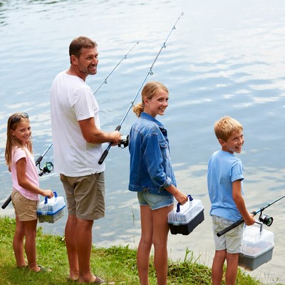 Family fishing by the lake on a sunny day