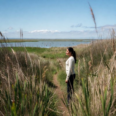 Woman walking in nature by a lake