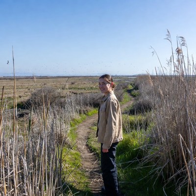 Woman walking on nature path in a wetland
