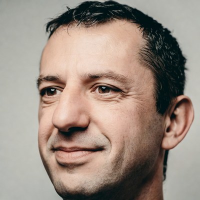 Man with short hair smiling at the camera