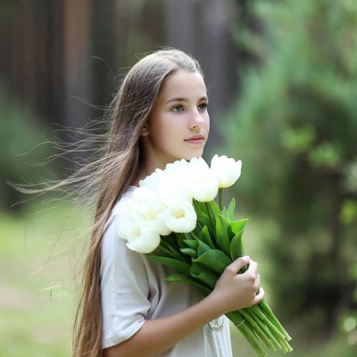 Girl with flowers in the forest