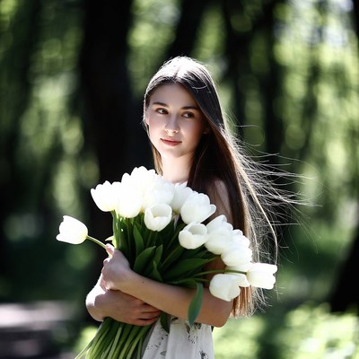 Woman with bouquet of tulips in park
