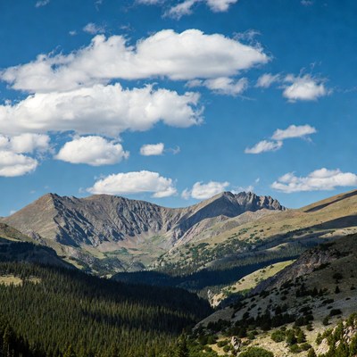 Mountain view with clouds and trees