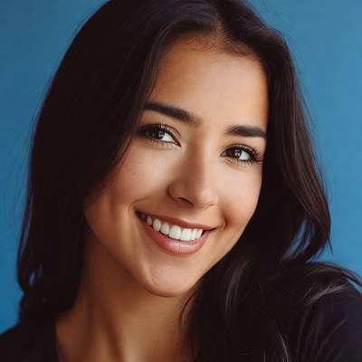 Smiling woman with dark hair and blue background