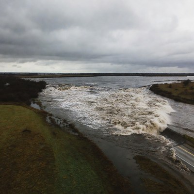 River flows under cloudy skies