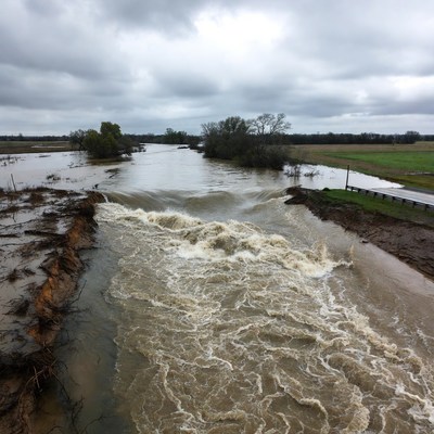 Flood waters overflow along the riverbank