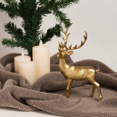 Gold reindeer by christmas tree